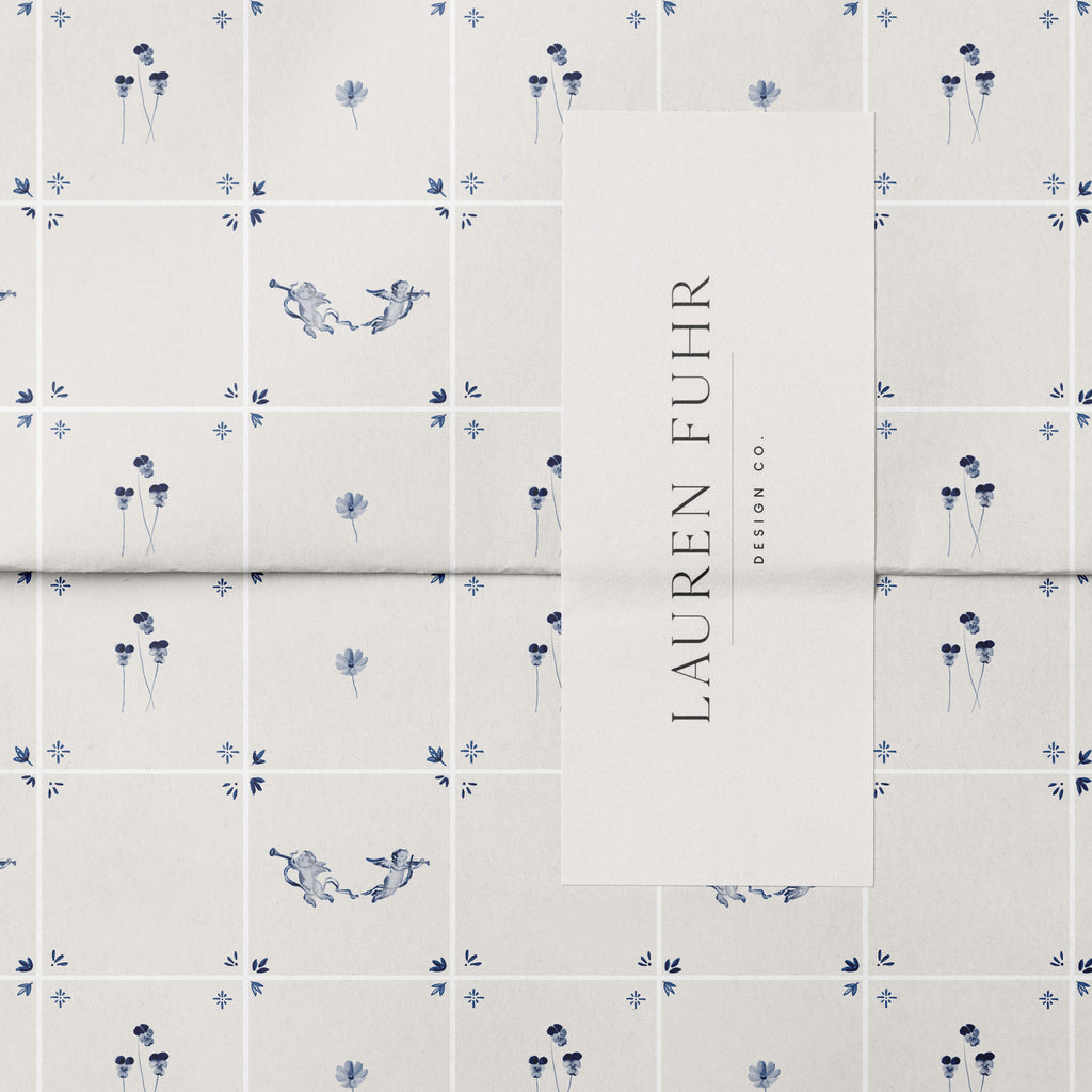 Tile pattern with small birds and flowers on a light blue background, featuring the brand 'Lauren Fuhr'.
